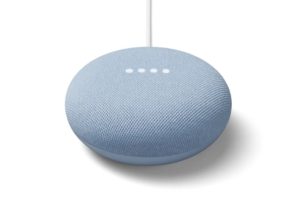 Google Nest Mini smart speaker in light blue with a fabric surface and four LED lights.