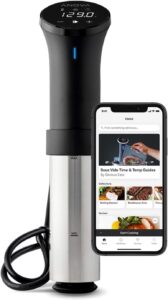 Anova Precision Cooker next to a smartphone displaying the sous vide app with cooking guides and recipes.