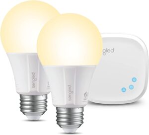 Two Sengled smart light bulbs glowing warm white with a smart hub device in the background.