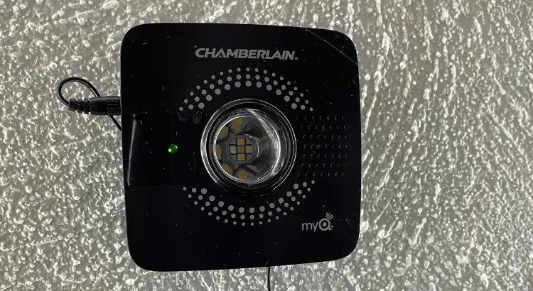 Chamberlain myQ Smart Garage Control mounted on a textured ceiling.