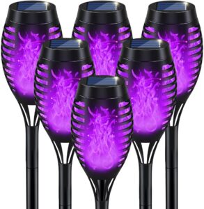 Purple flame solar torch lights for outdoor Halloween ambiance.